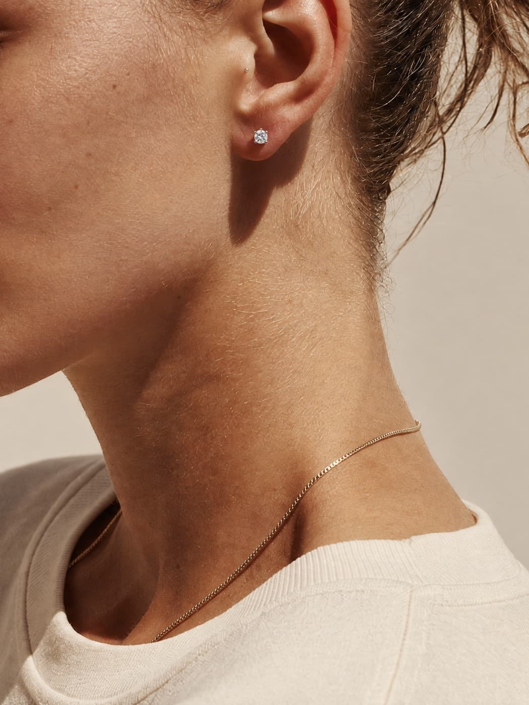 Woman wearing a JLD moissanite stud earring